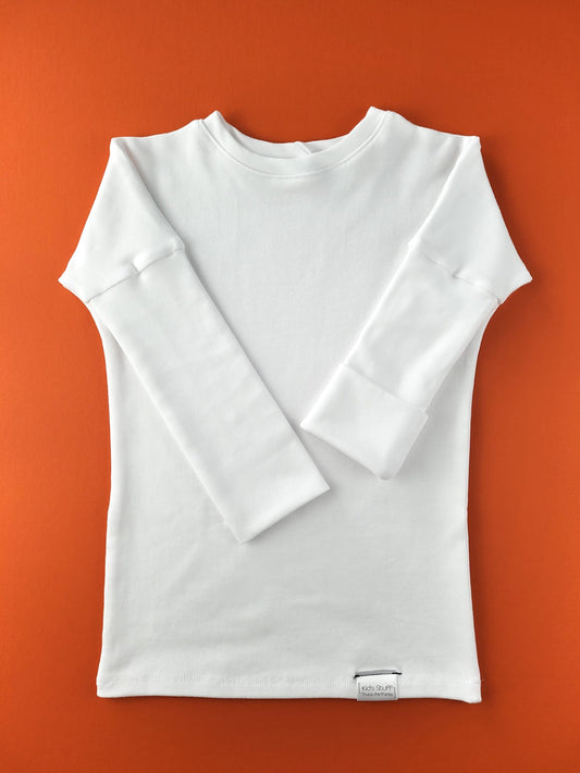 White grow-with-me shirt for toddlers and kids, designed to be worn as a dress, tunic, or long shirt. Seamless shoulders and soft, eco-friendly fabric. Ethically made in Canada.