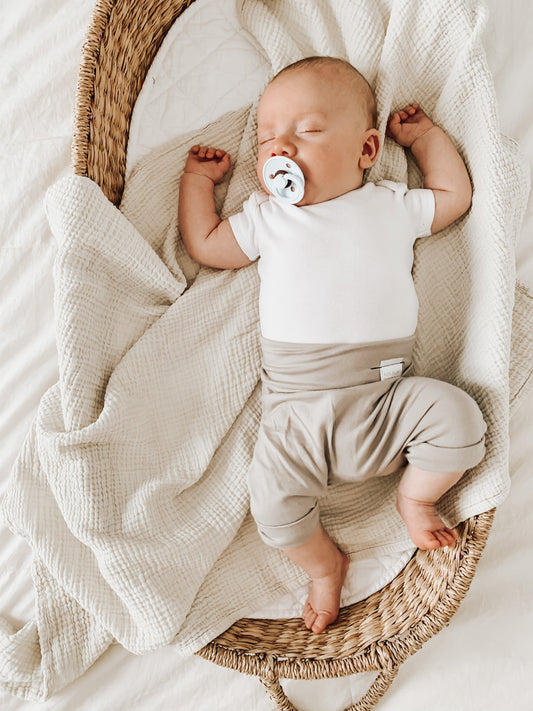 Taupe grow-with-me shorts for kids, made from soft organic cotton with a stretchy, foldable waistband. Ethically made in Canada for a sustainable and comfy fit.