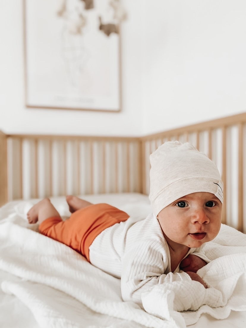 Soft and stretchy Heather cream beanie for kids, made from eco-friendly fabric. Ethically crafted in Canada, featuring a fold-over brim and minimalist design