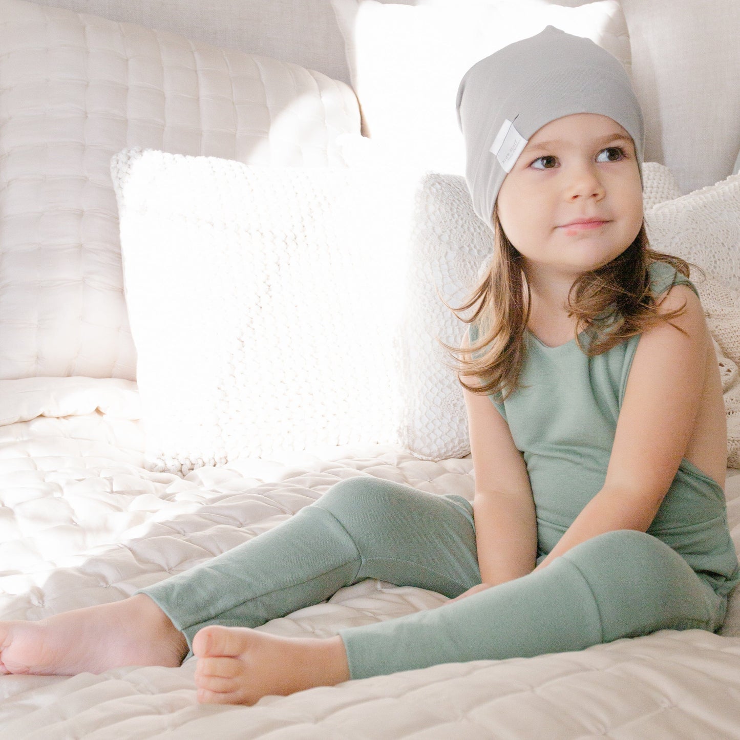 Soft and stretchy taupe beanie for kids, made from eco-friendly fabric. Ethically crafted in Canada, featuring a fold-over brim and minimalist design