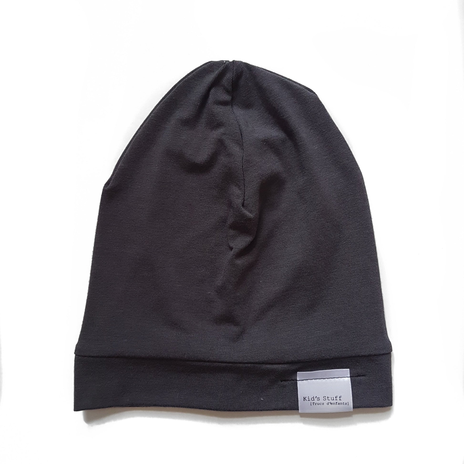 Soft and stretchy dark grey beanie for kids, made from eco-friendly fabric. Ethically crafted in Canada, featuring a fold-over brim and minimalist design